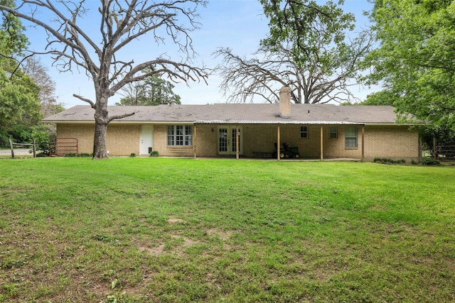 603 Sunnyvale Ln, Fairfield, TX 75840 - back of house with a lawn, brick siding, french doors, and a chimney