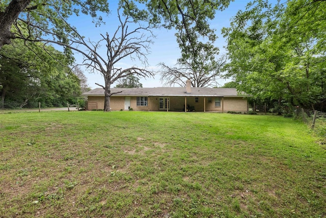 603 Sunnyvale Ln, Fairfield, TX 75840 - back of property with a yard, fence, and a chimney