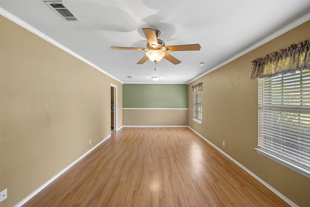 603 Sunnyvale Ln, Fairfield, TX 75840 - spare room with visible vents, crown molding, wood finished floors, baseboards, and a ceiling fan