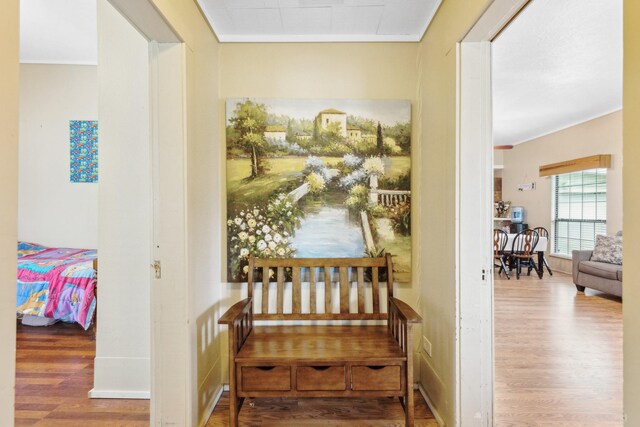 corridor featuring crown molding and wood finished floors