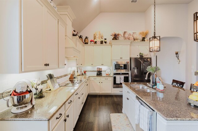 kitchen with stainless steel appliances, high vaulted ceiling, light stone countertops, and a sink
