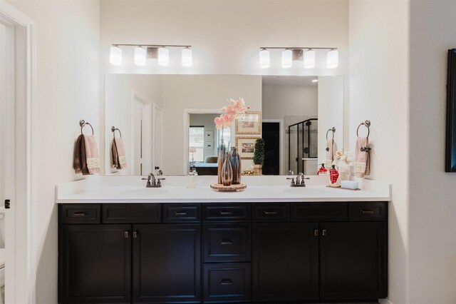 ensuite bathroom with a sink, a stall shower, double vanity, and connected bathroom