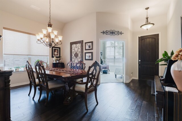 dining space featuring dark wood-style flooring, an inviting chandelier, and a wealth of natural light
