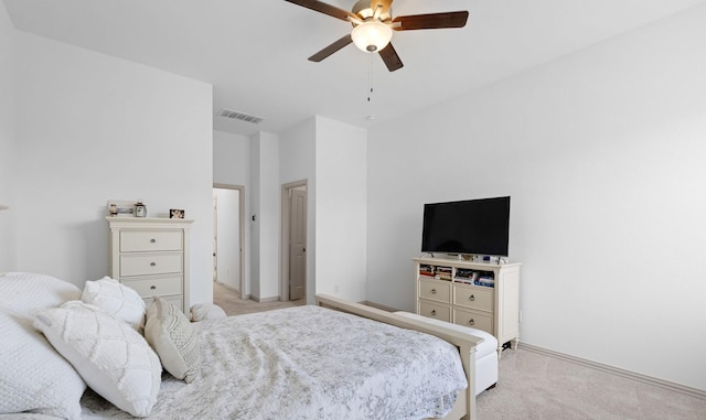 bedroom featuring a ceiling fan, visible vents, and light carpet