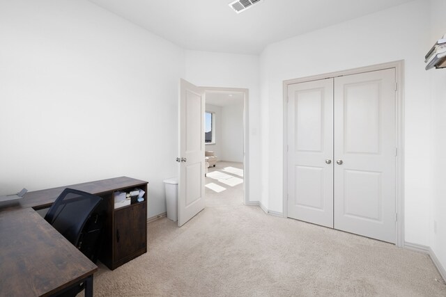 office with light colored carpet, baseboards, and visible vents
