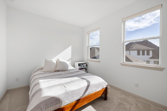 carpeted bedroom with baseboards