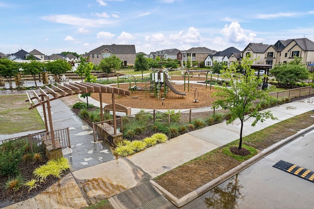 view of property's community with fence, a residential view, and playground community