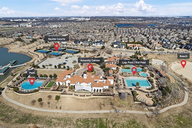 birds eye view of property with a water view and a residential view