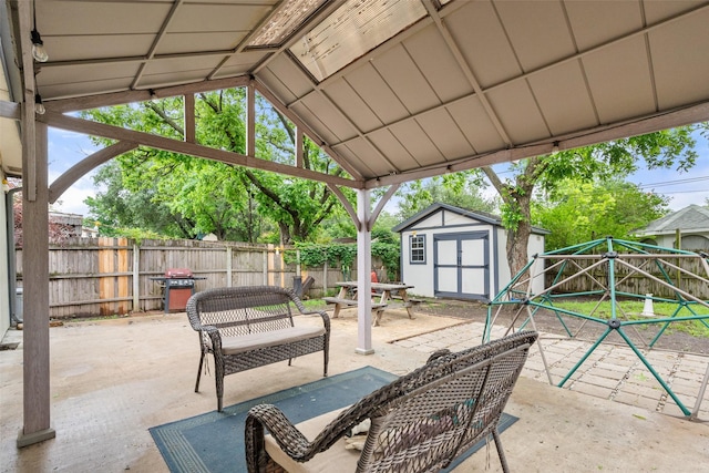 517 Curts Dr, Grand Prairie, TX 75052 - view of patio featuring a storage shed, an outbuilding, a fenced backyard, and area for grilling
