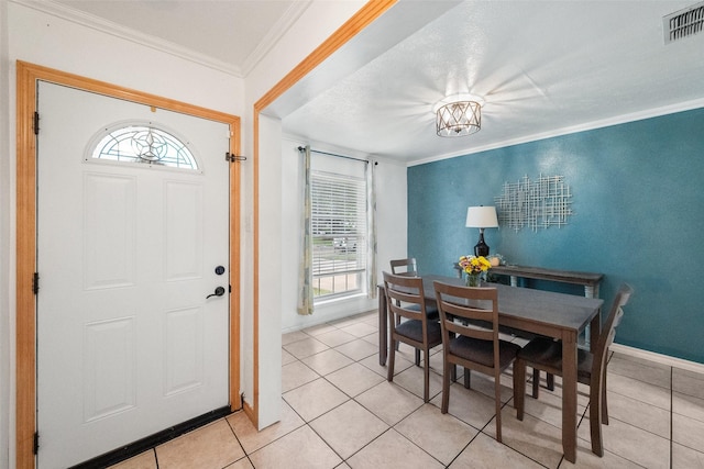 517 Curts Dr, Grand Prairie, TX 75052 - dining room featuring visible vents, baseboards, crown molding, and light tile patterned flooring