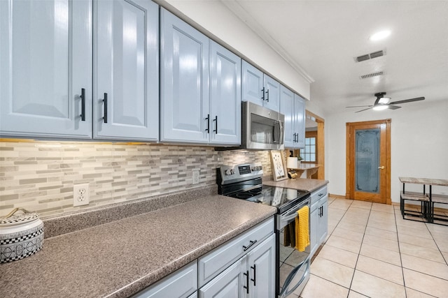 517 Curts Dr, Grand Prairie, TX 75052 - kitchen featuring stainless steel appliances, visible vents, decorative backsplash, and light tile patterned floors