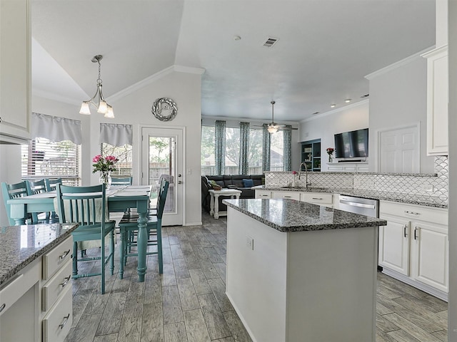 kitchen with crown molding, dishwasher, and a wealth of natural light