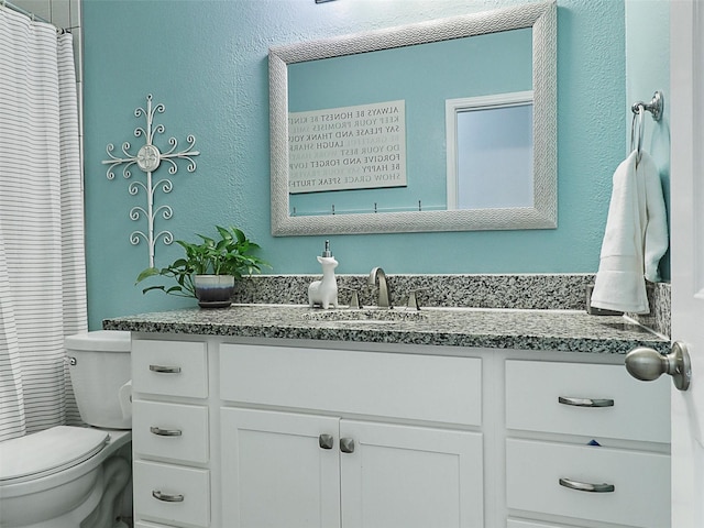 full bath featuring toilet and vanity