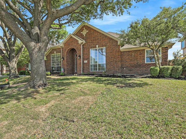 ranch-style house with brick siding and a front yard