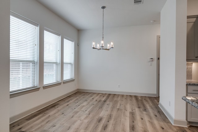 4402 Cypress Thorn Dr, Arlington, TX 76005 - unfurnished dining area with light wood finished floors, a chandelier, and baseboards