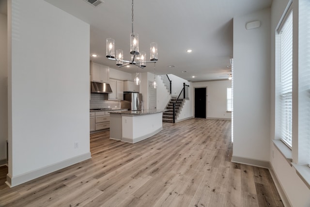4402 Cypress Thorn Dr, Arlington, TX 76005 - kitchen with freestanding refrigerator, open floor plan, under cabinet range hood, recessed lighting, and a chandelier
