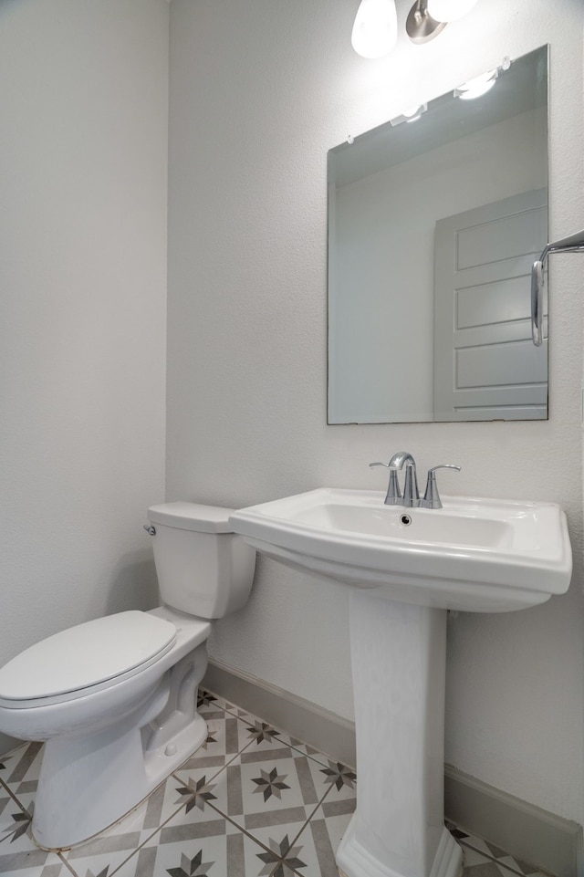 4402 Cypress Thorn Dr, Arlington, TX 76005 - half bath with toilet, tile patterned flooring, a sink, and baseboards