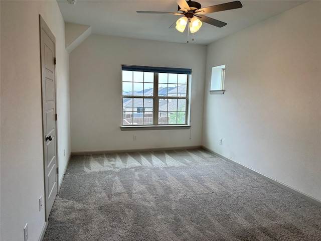 empty room with baseboards, a ceiling fan, and carpet flooring