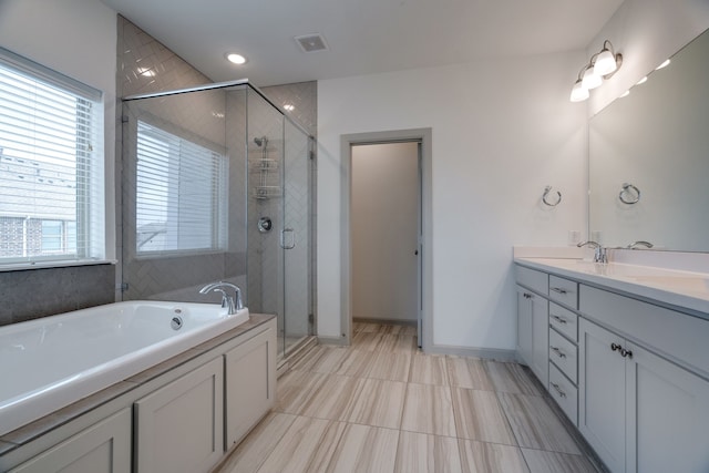 4402 Cypress Thorn Dr, Arlington, TX 76005 - bathroom featuring double vanity, a garden tub, a stall shower, and baseboards