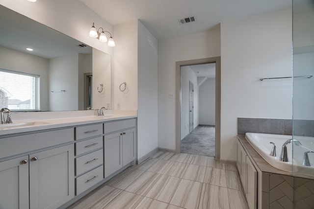 4402 Cypress Thorn Dr, Arlington, TX 76005 - bathroom featuring double vanity, a garden tub, and baseboards