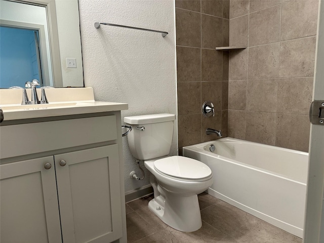 bathroom with vanity, a textured wall, washtub / shower combination, and toilet