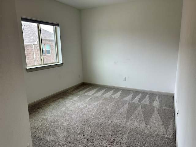 unfurnished room featuring baseboards and carpet flooring