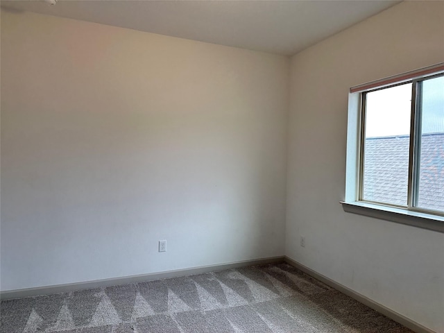 unfurnished room featuring baseboards, a healthy amount of sunlight, and carpet