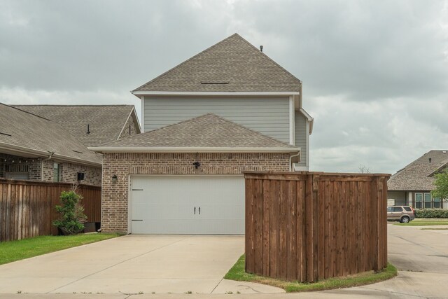 4402 Cypress Thorn Dr, Arlington, TX 76005 - view of front facade featuring brick siding, roof with shingles, an attached garage, and concrete driveway