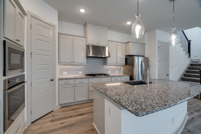 4402 Cypress Thorn Dr, Arlington, TX 76005 - kitchen with under cabinet range hood, appliances with stainless steel finishes, light wood-type flooring, a sink, and recessed lighting