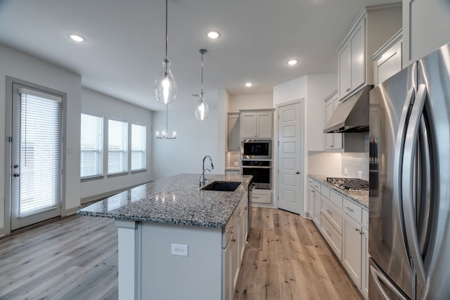 4402 Cypress Thorn Dr, Arlington, TX 76005 - kitchen with appliances with stainless steel finishes, a sink, under cabinet range hood, light wood-style flooring, and tasteful backsplash