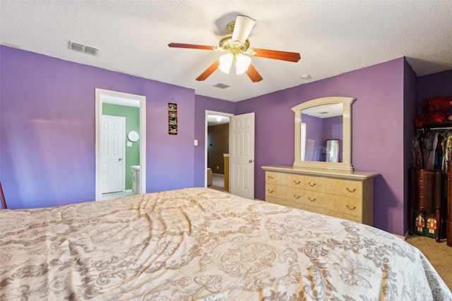 3065 Coolwood Ln, Rockwall, TX 75032 - carpeted bedroom with a textured ceiling, a ceiling fan, and ensuite bathroom