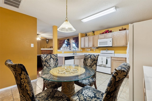 3065 Coolwood Ln, Rockwall, TX 75032 - kitchen featuring white appliances, light countertops, a sink, light tile patterned flooring, and a textured ceiling