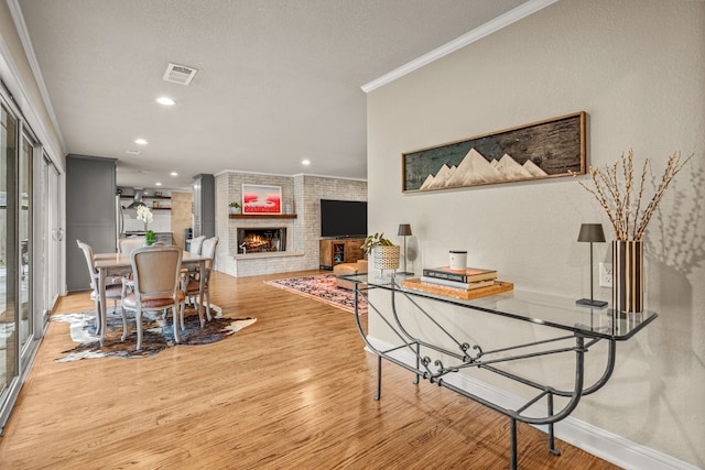 3200 Spanish Oak Dr, Fort Worth, TX 76109 - dining room featuring visible vents, crown molding, a fireplace, wood finished floors, and recessed lighting