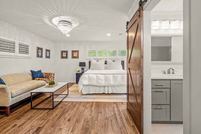 3200 Spanish Oak Dr, Fort Worth, TX 76109 - bedroom with visible vents, a barn door, a sink, an inviting chandelier, and recessed lighting