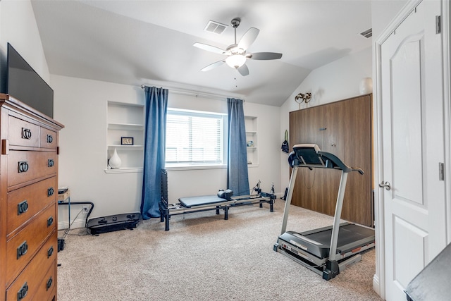 workout area featuring carpet flooring, a ceiling fan, visible vents, and vaulted ceiling