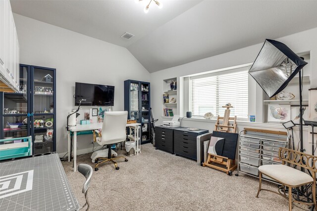 carpeted office with visible vents and lofted ceiling