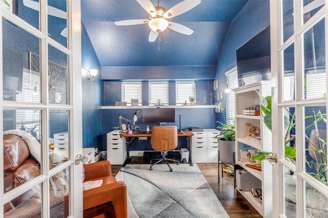 office area featuring built in desk, ceiling fan, wood finished floors, and vaulted ceiling