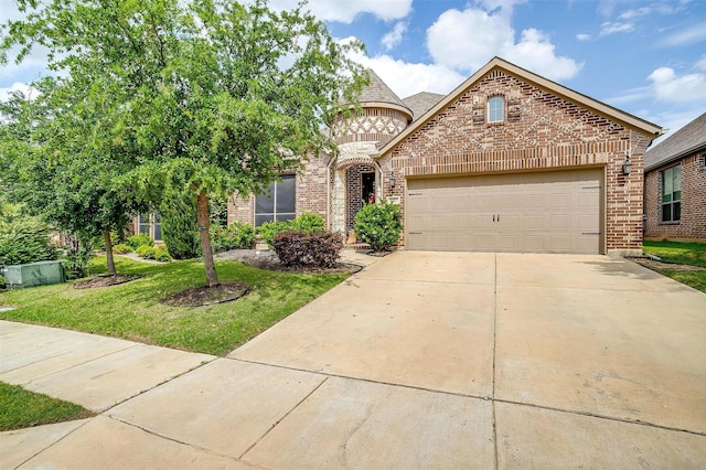 8357 Blue Periwinkle Ln, Fort Worth, TX 76123 - french provincial home featuring a garage, concrete driveway, a front lawn, and brick siding