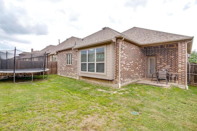 8357 Blue Periwinkle Ln, Fort Worth, TX 76123 - rear view of house featuring a patio, brick siding, a fenced backyard, and a trampoline