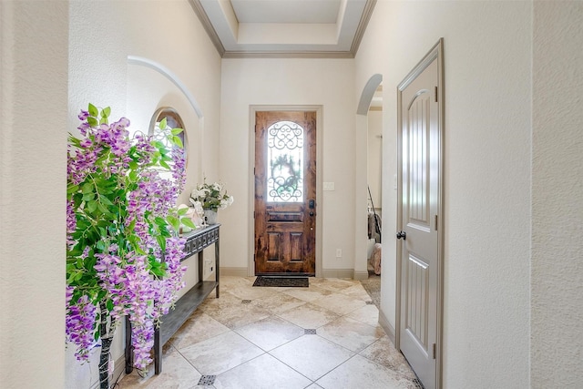 8357 Blue Periwinkle Ln, Fort Worth, TX 76123 - foyer featuring crown molding, a textured wall, baseboards, a raised ceiling, and arched walkways