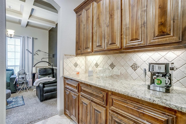 8357 Blue Periwinkle Ln, Fort Worth, TX 76123 - kitchen featuring light stone counters, decorative backsplash, coffered ceiling, and beam ceiling
