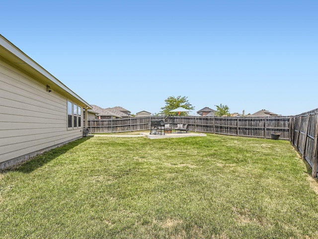 view of yard with a fenced backyard and a patio