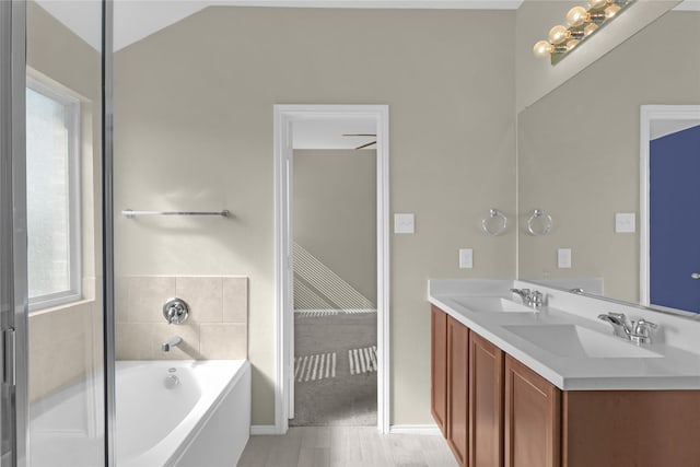 5320 Creek Hill Ln, Fort Worth, TX 76179 - bathroom with a bath, baseboards, double vanity, and wood finished floors
