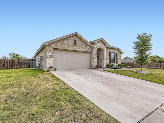 view of front of property with concrete driveway, an attached garage, fence, and stone siding