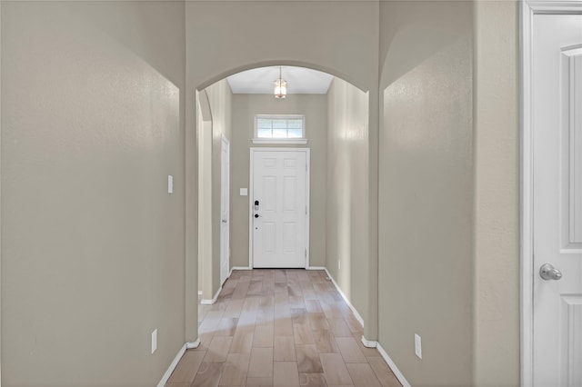 5320 Creek Hill Ln, Fort Worth, TX 76179 - doorway with arched walkways, light wood finished floors, and baseboards