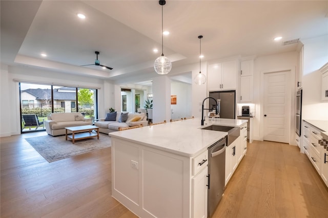 1400 Island Vista Dr, Arlington, TX 76005 - kitchen featuring a sink, light wood-style floors, stainless steel appliances, a tray ceiling, and visible vents