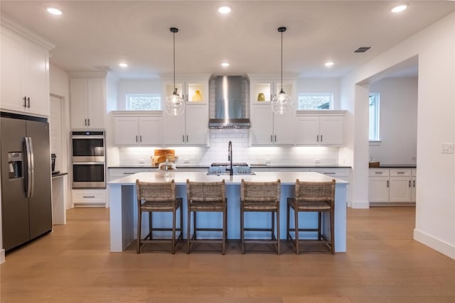 1400 Island Vista Dr, Arlington, TX 76005 - kitchen with white cabinets, appliances with stainless steel finishes, wall chimney exhaust hood, and light wood-type flooring