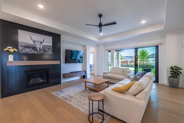 1400 Island Vista Dr, Arlington, TX 76005 - living room with a large fireplace, a ceiling fan, a tray ceiling, and wood finished floors