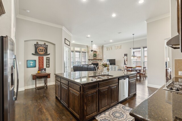 kitchen featuring dark brown cabinets, a sink, stainless steel appliances, recessed lighting, and dark wood-style floors