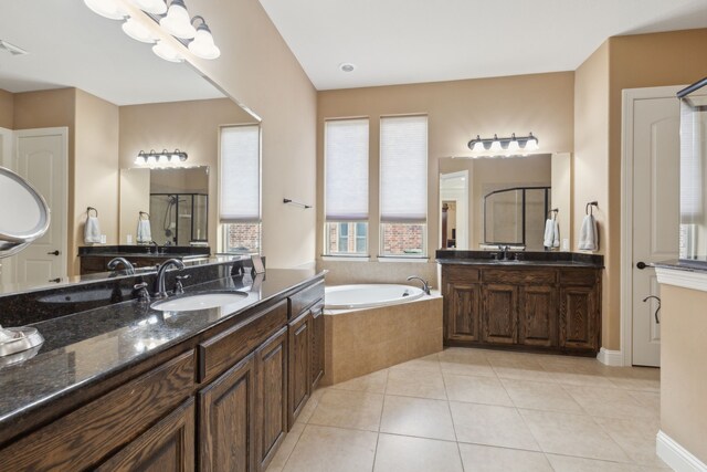 full bathroom featuring a sink, tile patterned floors, a garden tub, and a stall shower